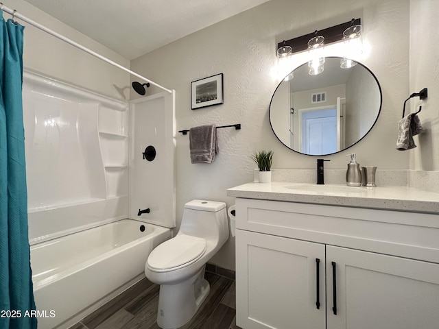 full bathroom with vanity, toilet, hardwood / wood-style floors, and shower / bath combo