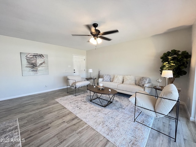 living room featuring hardwood / wood-style floors and ceiling fan