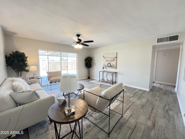 living room with ceiling fan and light wood-type flooring