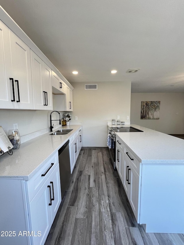 kitchen with appliances with stainless steel finishes, sink, and white cabinets