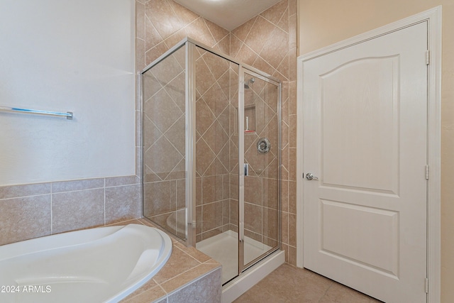 bathroom with tile patterned floors and shower with separate bathtub