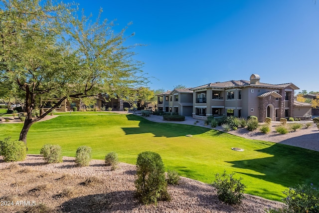 view of property's community featuring a yard