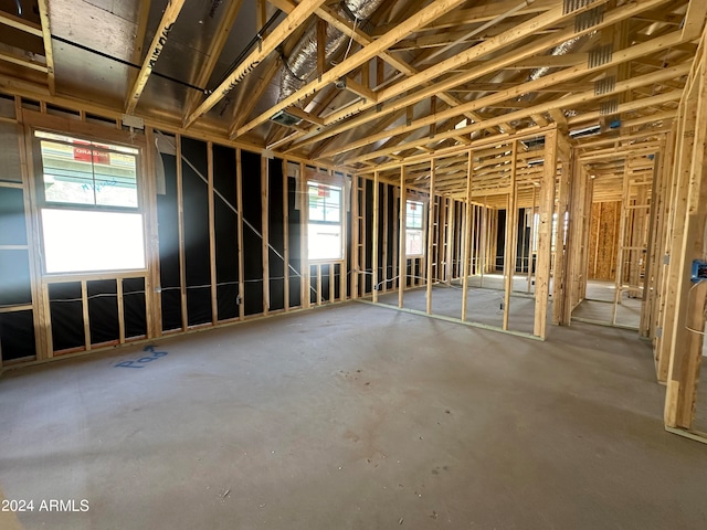 misc room with a healthy amount of sunlight and concrete flooring