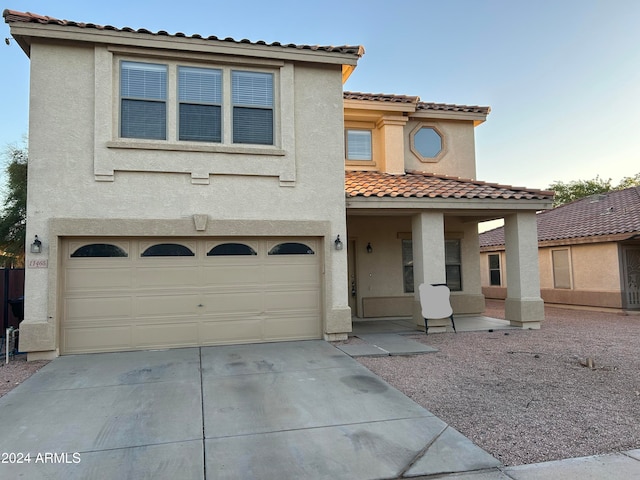 mediterranean / spanish home with a garage