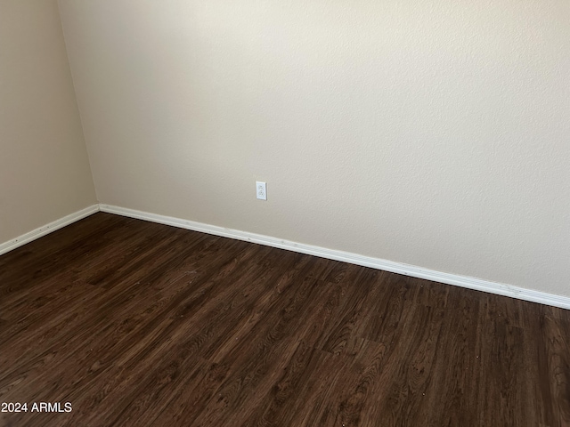 empty room with dark wood-type flooring