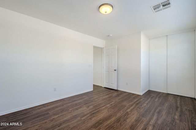 empty room with dark hardwood / wood-style floors