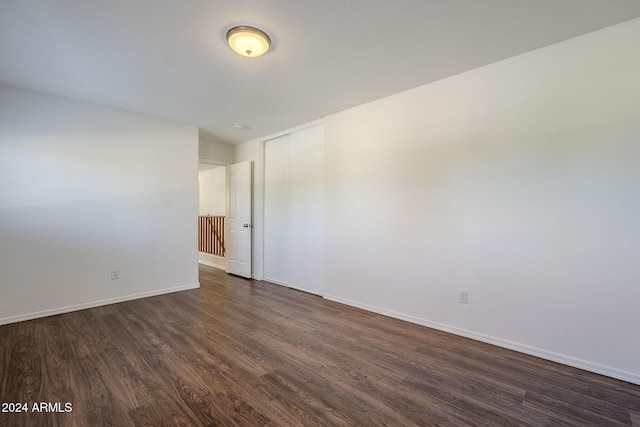 unfurnished room featuring dark hardwood / wood-style flooring