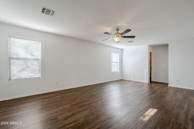 unfurnished room featuring ceiling fan and dark hardwood / wood-style flooring