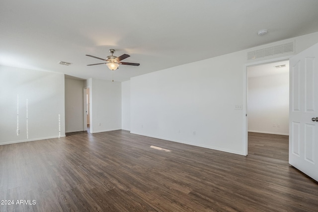 empty room featuring ceiling fan and dark wood-type flooring