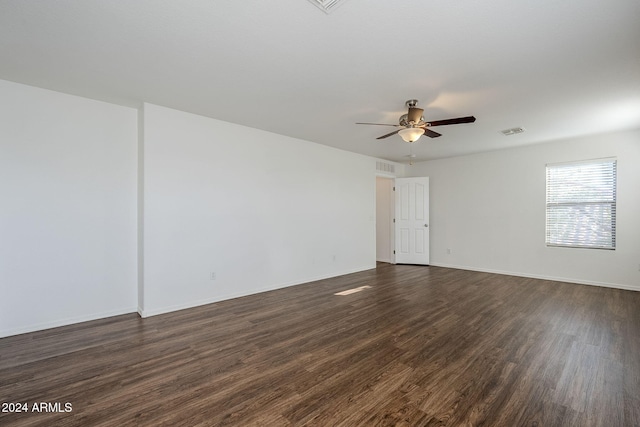 unfurnished room with ceiling fan and dark wood-type flooring