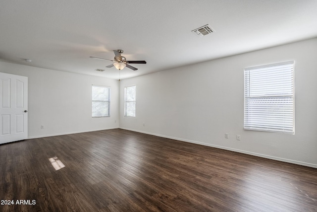 empty room featuring ceiling fan and dark hardwood / wood-style floors