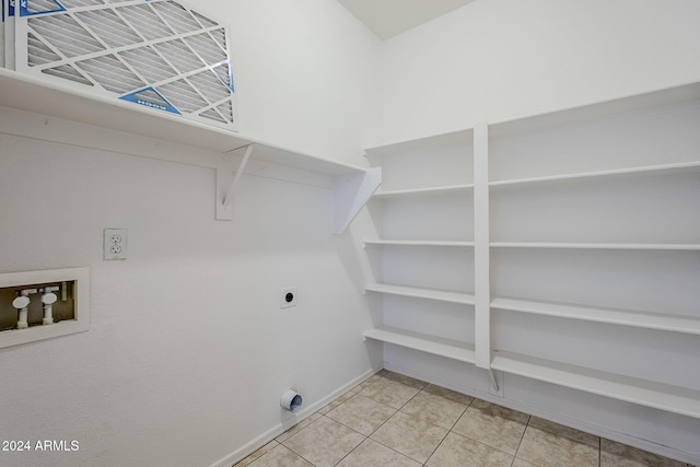 clothes washing area featuring hookup for an electric dryer, washer hookup, and tile patterned floors