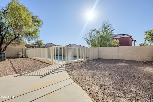 view of yard with a fenced in pool