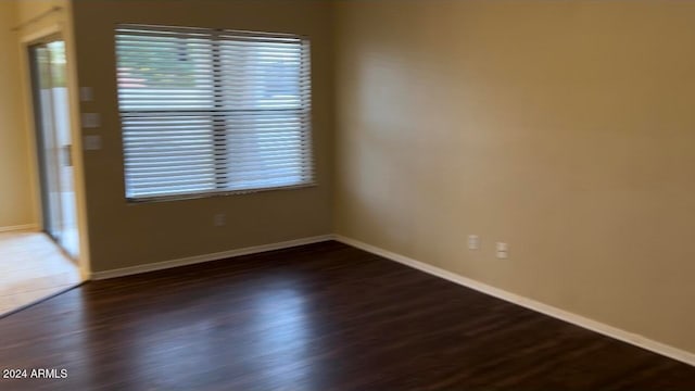 empty room with dark wood-type flooring