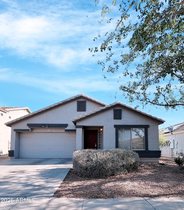 16706 W Belleview St, Goodyear, AZ 85338 - view of front of house featuring stucco siding, a garage, and driveway