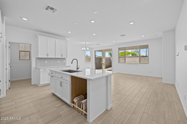 15788 W Georgia Dr W, Surprise, AZ 85379 - kitchen featuring a sink, baseboards, light countertops, white cabinets, and recessed lighting