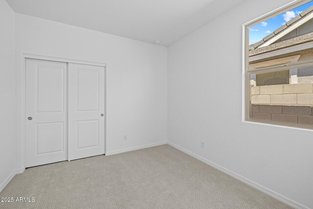 15788 W Georgia Dr W, Surprise, AZ 85379 - unfurnished bedroom with baseboards, carpet flooring, and a closet