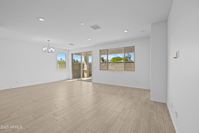 15788 W Georgia Dr W, Surprise, AZ 85379 - empty room featuring a chandelier, baseboards, light wood finished floors, and recessed lighting