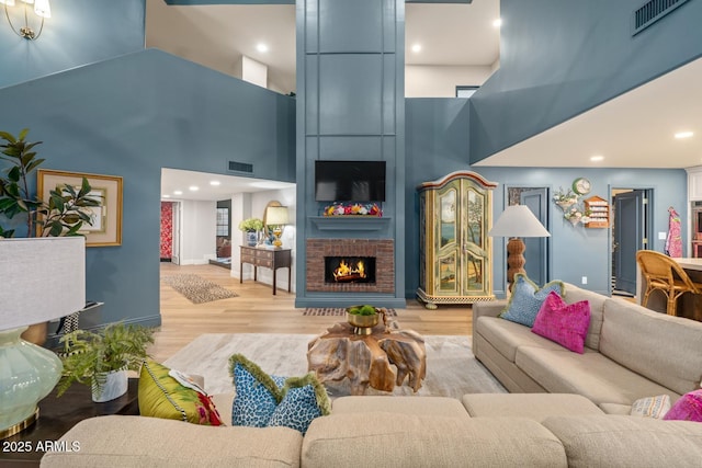 8219 S Pecan Grove Cir, Tempe, AZ 85284 - living room featuring a towering ceiling, wood finished floors, a fireplace, baseboards, and recessed lighting