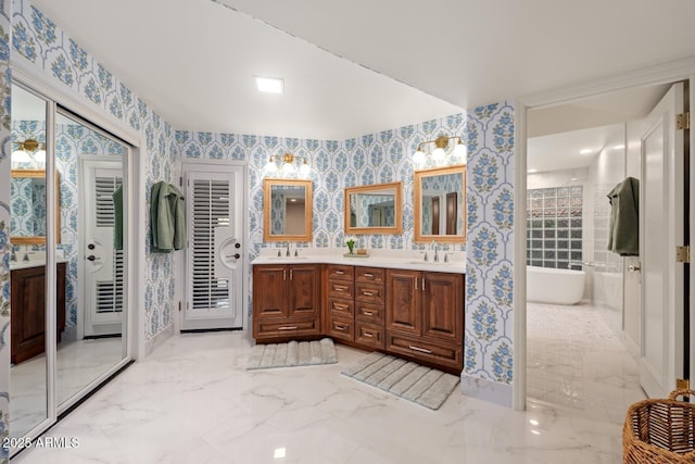 8219 S Pecan Grove Cir, Tempe, AZ 85284 - full bathroom with wallpapered walls, double vanity, a freestanding bath, and marble finish flooring