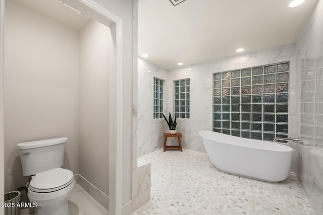 8219 S Pecan Grove Cir, Tempe, AZ 85284 - full bath featuring a freestanding tub, toilet, recessed lighting, and tile walls