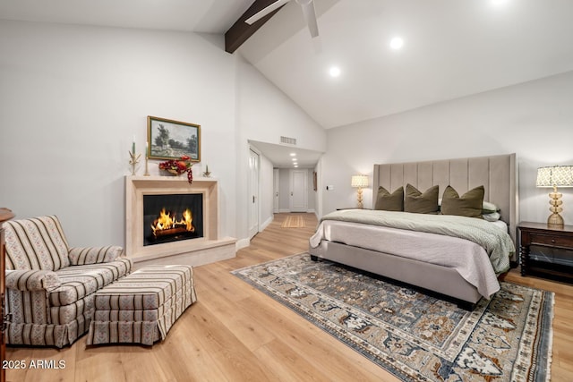 8219 S Pecan Grove Cir, Tempe, AZ 85284 - bedroom featuring beam ceiling, high vaulted ceiling, wood finished floors, a lit fireplace, and baseboards