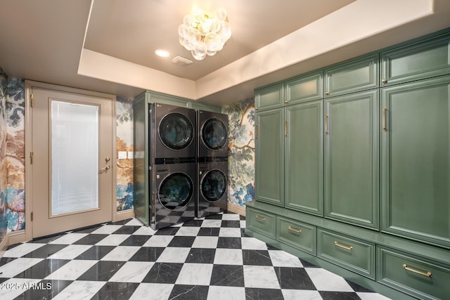 8219 S Pecan Grove Cir, Tempe, AZ 85284 - laundry room featuring stacked washer and clothes dryer, cabinet space, and a chandelier