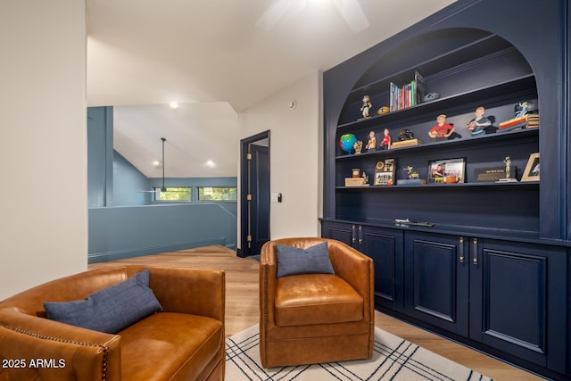 8219 S Pecan Grove Cir, Tempe, AZ 85284 - living area featuring light wood-style flooring, ceiling fan, vaulted ceiling, and built in features