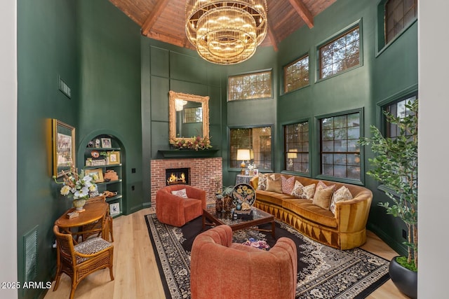 8219 S Pecan Grove Cir, Tempe, AZ 85284 - living room featuring high vaulted ceiling, wood ceiling with exposed beams, a chandelier, a brick fireplace, and wood finished floors
