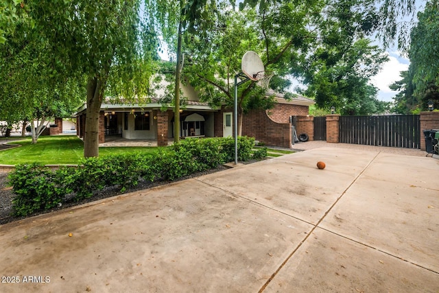 8219 S Pecan Grove Cir, Tempe, AZ 85284 - view of front of home featuring a gate, brick siding, driveway, and a porch