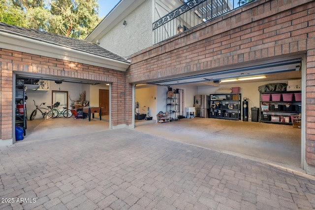 8219 S Pecan Grove Cir, Tempe, AZ 85284 - garage featuring decorative driveway, a garage door opener, and stainless steel refrigerator with ice dispenser