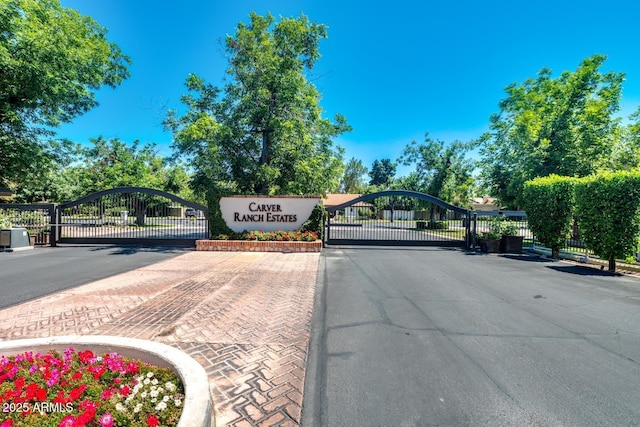 8219 S Pecan Grove Cir, Tempe, AZ 85284 - view of asphalt street with a gate, a gated entry, and curbs