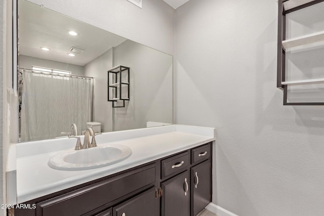 bathroom featuring recessed lighting and vanity