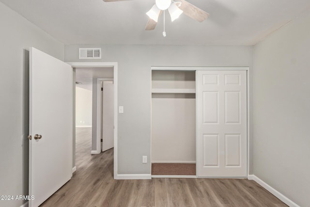 unfurnished bedroom with baseboards, visible vents, and wood finished floors