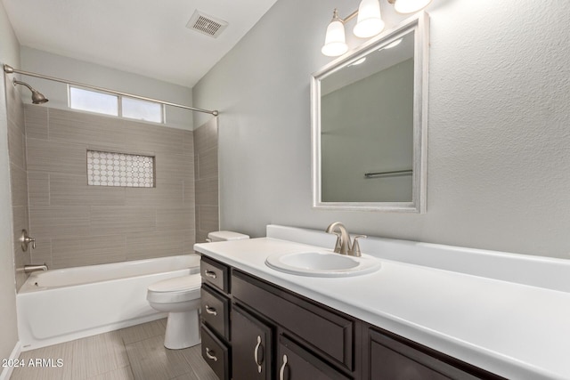 bathroom featuring toilet, shower / bathtub combination, vanity, and visible vents