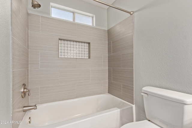 full bathroom with a textured wall,  shower combination, and toilet