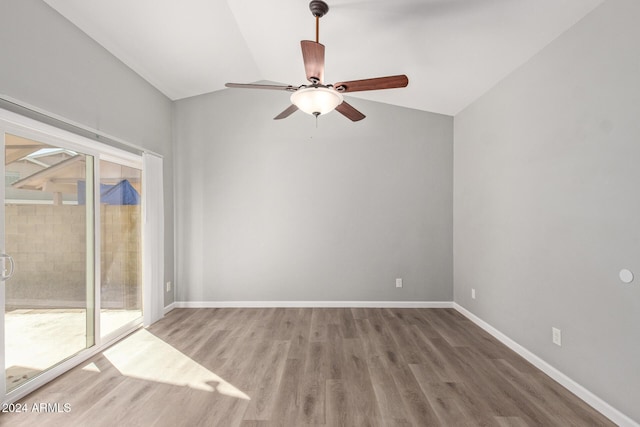 unfurnished room with ceiling fan, baseboards, vaulted ceiling, and wood finished floors