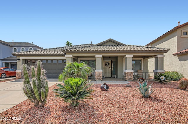 5502 N Ormondo Way, Litchfield Park, AZ 85340 - view of front of house with driveway, an attached garage, stucco siding, and covered porch