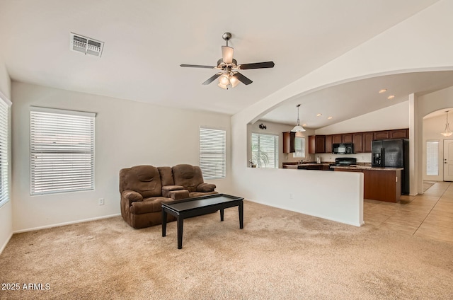 5502 N Ormondo Way, Litchfield Park, AZ 85340 - living room featuring arched walkways, light colored carpet, a ceiling fan, vaulted ceiling, and recessed lighting