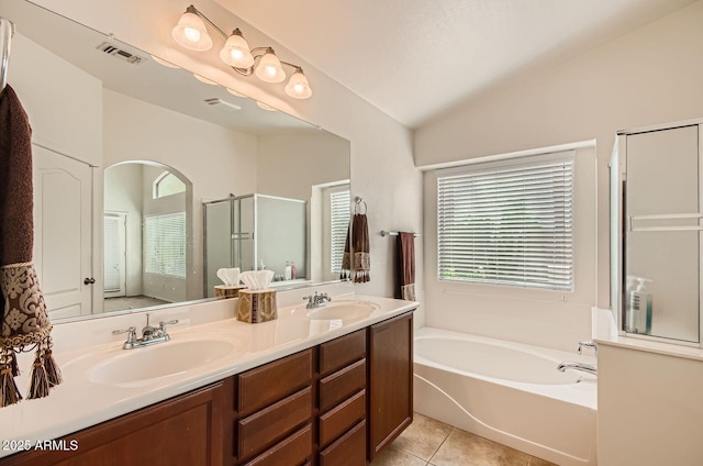 5502 N Ormondo Way, Litchfield Park, AZ 85340 - bathroom featuring a stall shower, a bath, double vanity, lofted ceiling, and tile patterned flooring