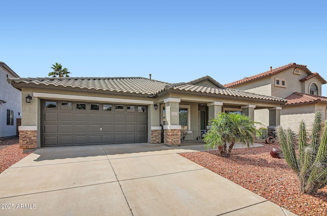 5502 N Ormondo Way, Litchfield Park, AZ 85340 - view of front facade with stone siding, driveway, an attached garage, covered porch, and stucco siding