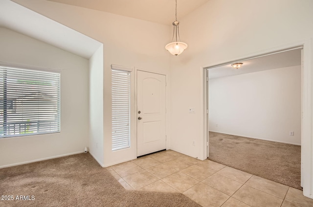 5502 N Ormondo Way, Litchfield Park, AZ 85340 - foyer featuring light colored carpet, lofted ceiling, light tile patterned floors, and baseboards