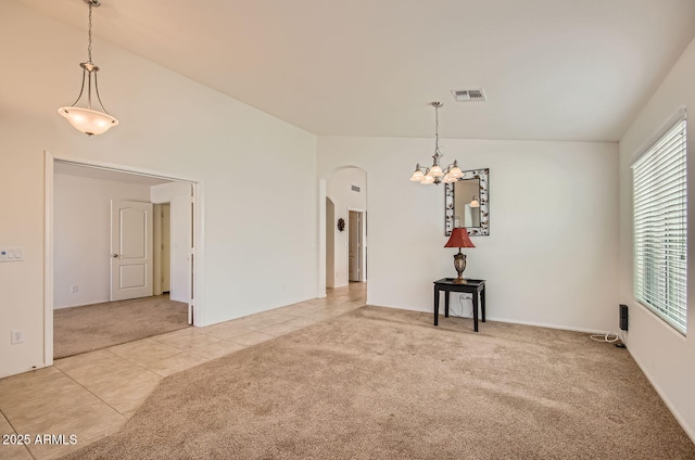 5502 N Ormondo Way, Litchfield Park, AZ 85340 - unfurnished dining area with arched walkways, light colored carpet, a chandelier, and light tile patterned floors