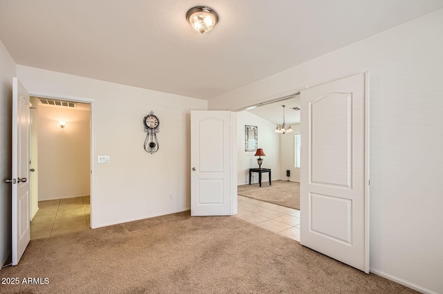 5502 N Ormondo Way, Litchfield Park, AZ 85340 - unfurnished room featuring light colored carpet, a chandelier, light tile patterned floors, and baseboards