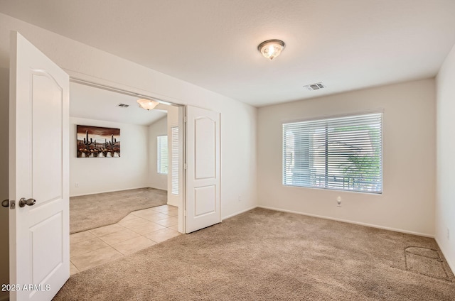 5502 N Ormondo Way, Litchfield Park, AZ 85340 - empty room with light carpet, light tile patterned floors, and baseboards