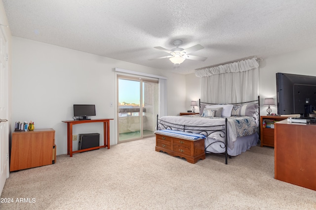 carpeted bedroom with a textured ceiling, access to outside, and ceiling fan