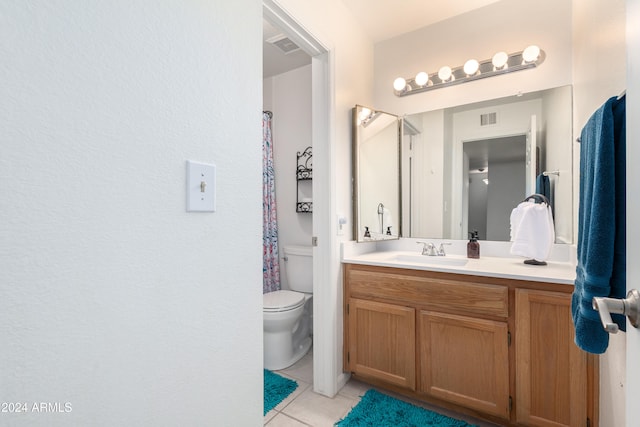 bathroom featuring tile patterned floors, vanity, and toilet