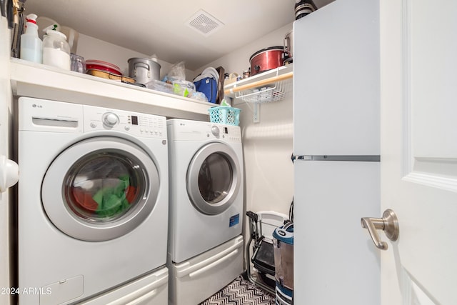 laundry room featuring washing machine and clothes dryer