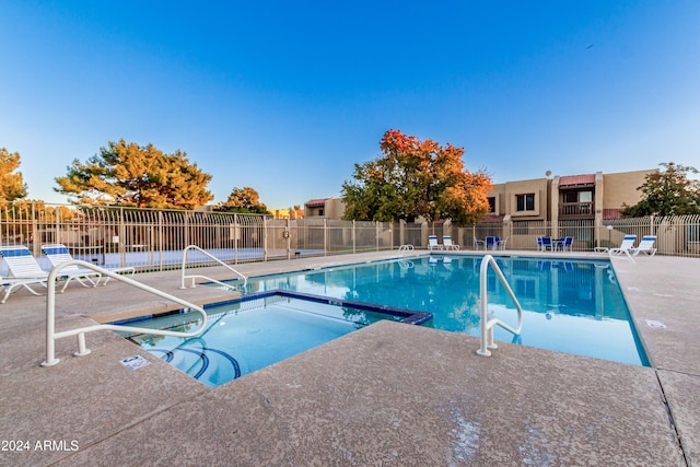 view of pool featuring a patio and a hot tub