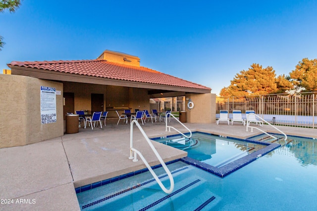 view of pool with a patio and a hot tub